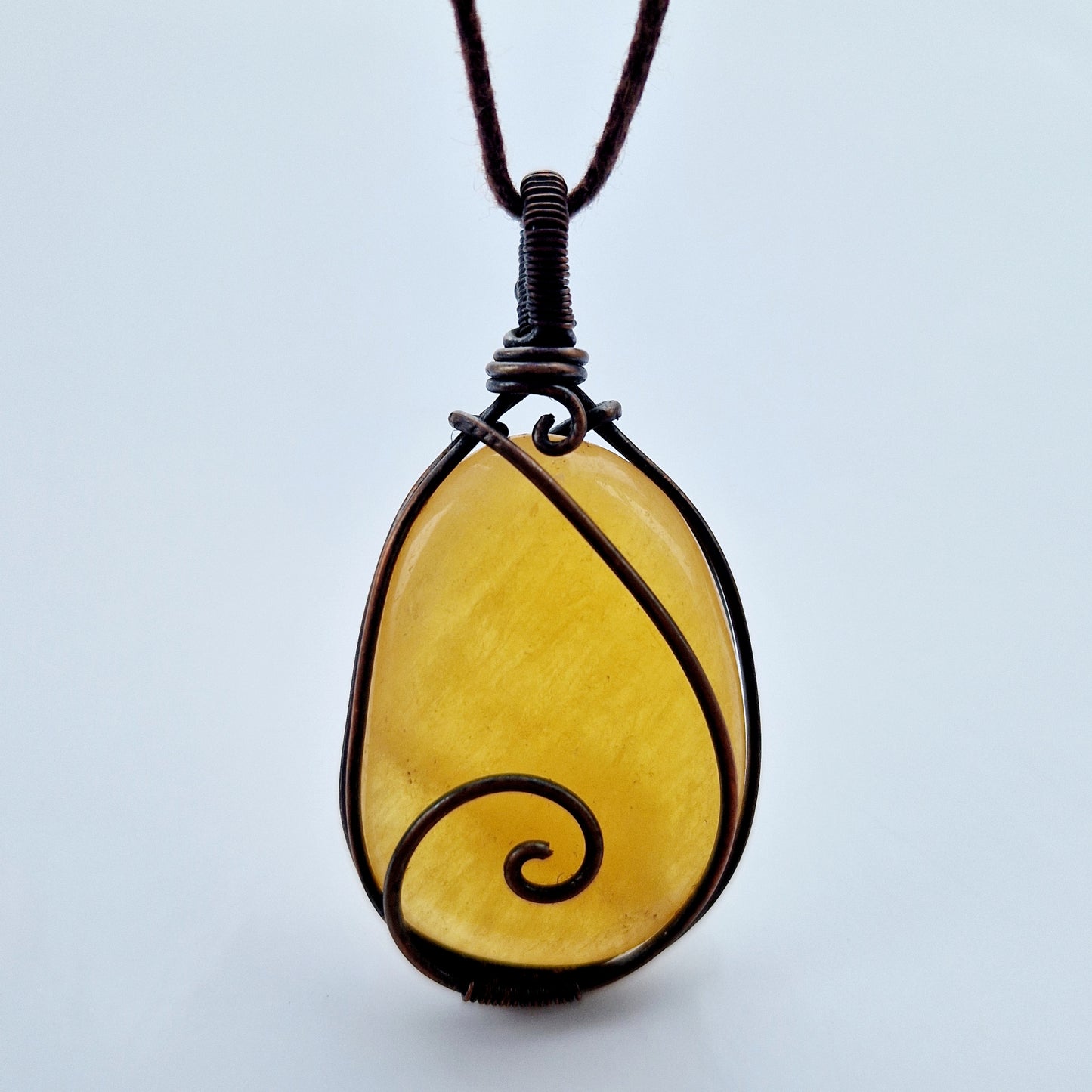 Wire wrapped orange calcite stone for grief support