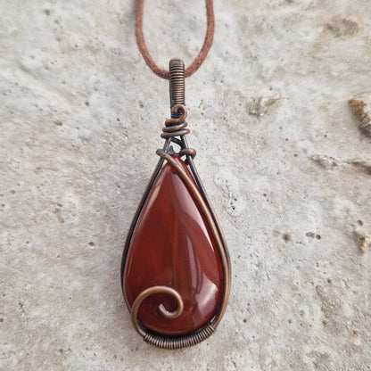 Carnelian teardrop imprinted with the life essence of a departed pet