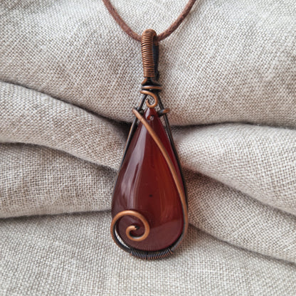 Copper wire wrapped healing carnelian pendant