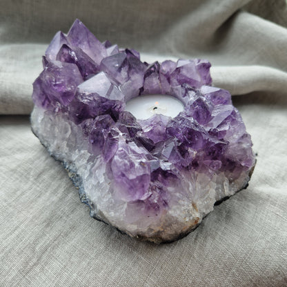 An imprinted amethyst geode tealight holder for restoring balance to emotions