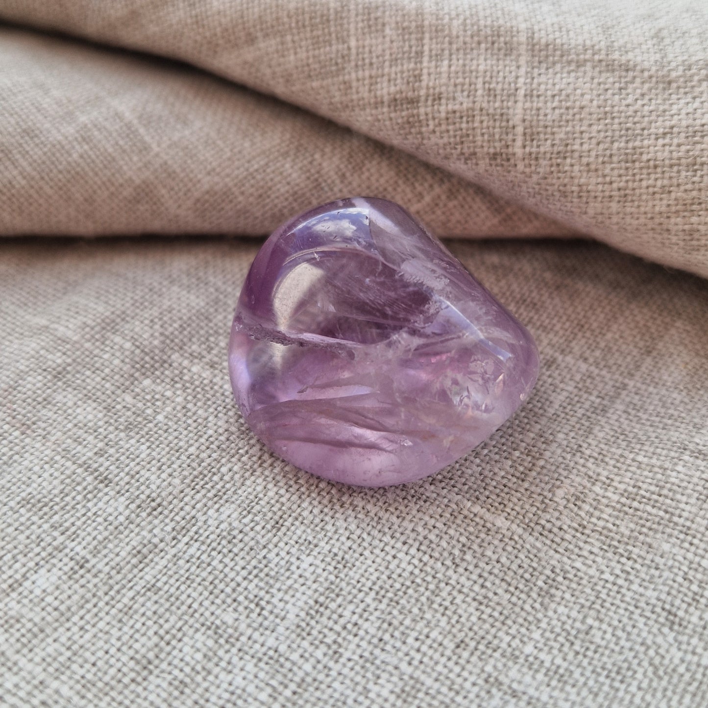 A palm sized amethyst imprinted crystal for emotional healing