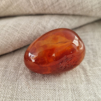 Carnelian palm crystal infused with the energy pattern of a departed loved one
