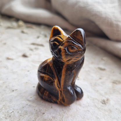 A tigers eye crystal cat that has been imprinted with the unique frequency of a cherished pet.