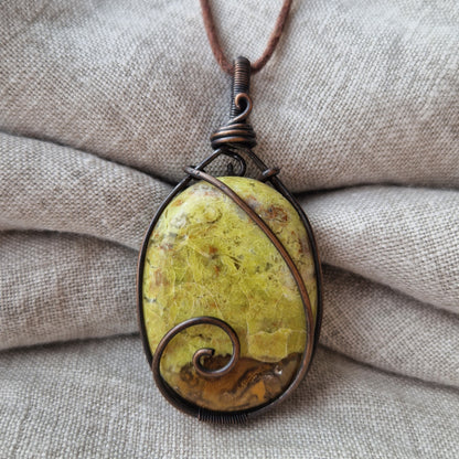 Close up of a wire wrapped healing green opal