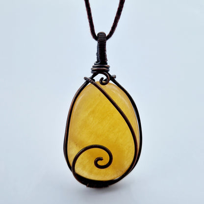 Wire wrapped orange calcite stone for grief support