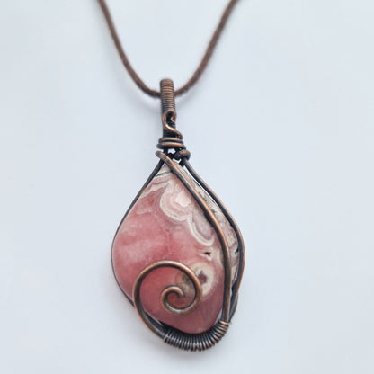 A rhodochrosite remembrance frequency imprinted healing crystal
