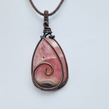 Copper wire wrapped rhodochrosite crystal pendant