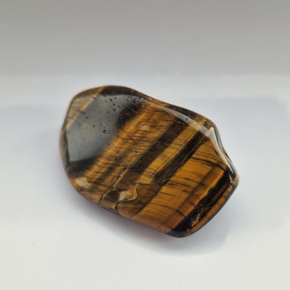 Energy infused palm crystal tigers eye memorial stone
